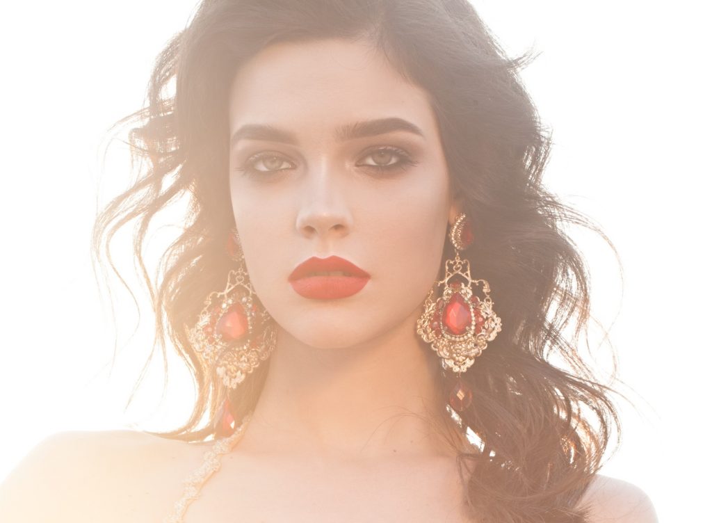 Woman with large earring using earring lift